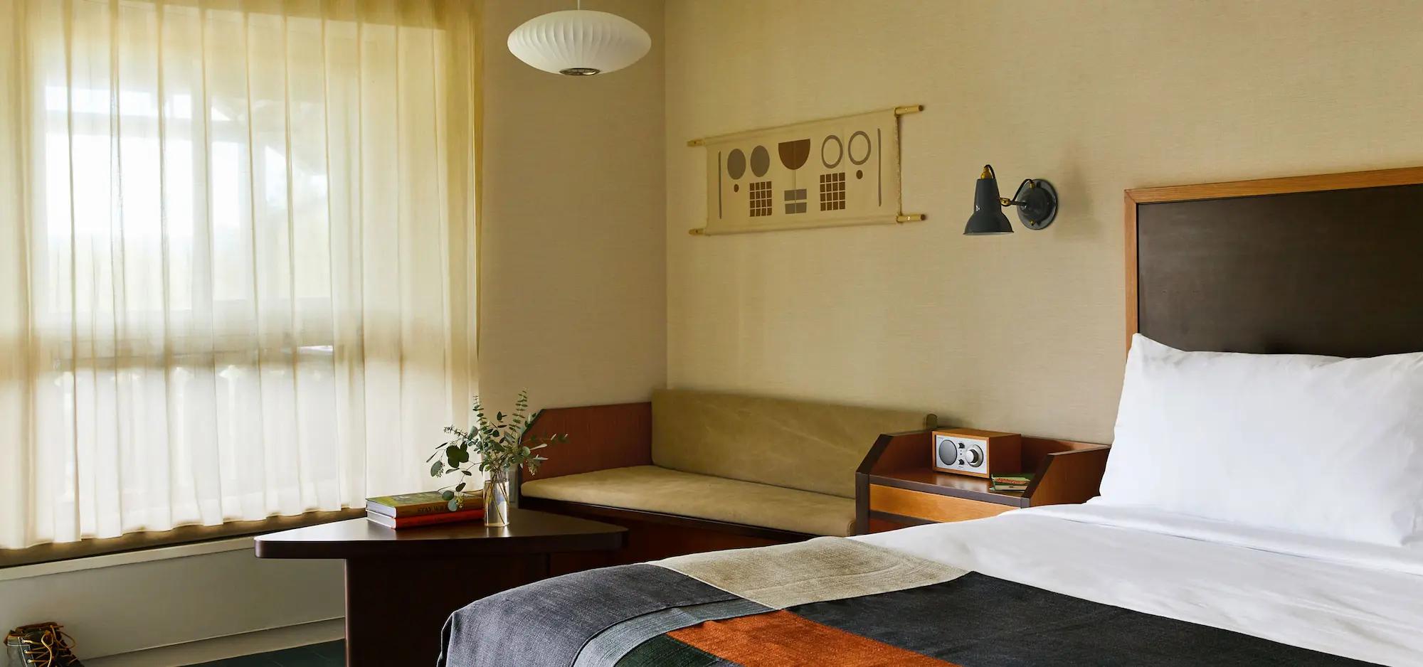 Modern, minimalist hotel room interior.